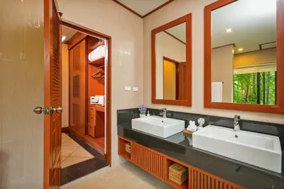 a bathroom with two sinks and two mirrors at Villa Raas 3BR Private PoolNaiharn beach in Nai Harn Beach