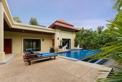 a house with a pool and a bench next to it at Villa Raas 3BR Private PoolNaiharn beach in Nai Harn Beach