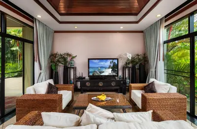 a living room with white furniture and a tv at Villa Raas 3BR Private PoolNaiharn beach in Nai Harn Beach