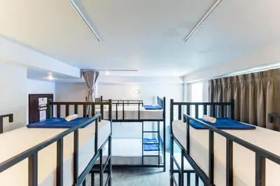 a room with four bunk beds in a dorm at Hip Hostel - SHA Plus in Patong Beach