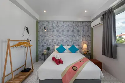 a bedroom with a bed with a red stuffed animal on it at Hip Hostel - SHA Plus in Patong Beach