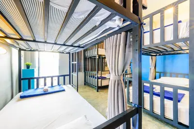 a room with two bunk beds in a dorm at Hip Hostel - SHA Plus in Patong Beach