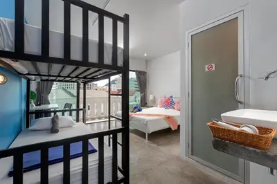 a bedroom with a bunk bed and a bathroom at Hip Hostel - SHA Plus in Patong Beach