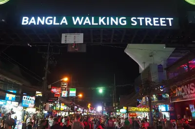 a crowd of people walking down a busy street at night at Hip Hostel - SHA Plus in Patong Beach