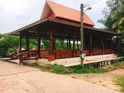 a pavilion with a dog sitting on the porch at Bussarin Mansion Koh Yao Yai in Ko Yao Yai