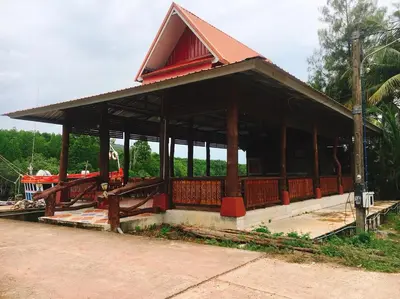 a pavilion with a building with a red roof at Bussarin Mansion Koh Yao Yai in Ko Yao Yai