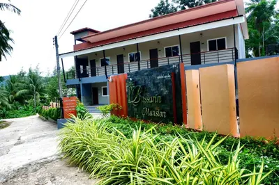 a house with a sign in front of it at Bussarin Mansion Koh Yao Yai in Ko Yao Yai