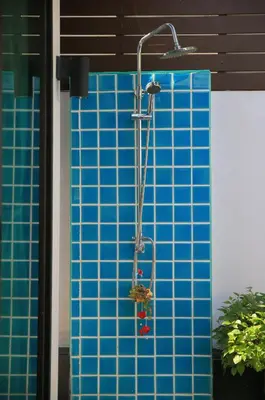 a shower with a blue tiled wall at Naiharn Beach Villa in Nai Harn Beach