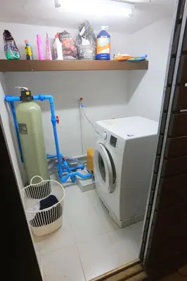 a kitchen with a washing machine in a room at Naiharn Beach Villa in Nai Harn Beach