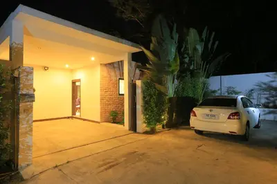 a white car parked in front of a house at Naiharn Beach Villa in Nai Harn Beach
