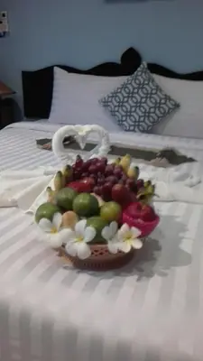 a bowl of fruit on top of a bed at La Piccola Patong in Patong Beach