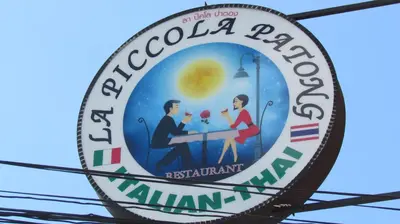 a sign for a local restaurant at La Piccola Patong in Patong Beach