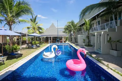 two inflatable flamingos in a swimming pool at a resort at Impress Resort in Thalang