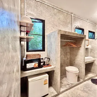 a kitchen with a sink and a microwave at Phuchada Residence in Nai Yang Beach