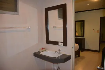 a bathroom with a sink and a mirror at Patong Moon Inn Residence in Patong Beach