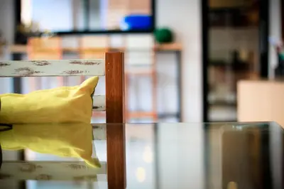 a yellow pillow sitting on top of a glass table at Vipa House Phuket - SHA Extra Plus in Chalong