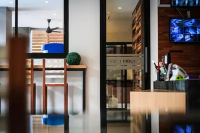 a room with a table and a chair and a mirror at Vipa House Phuket - SHA Extra Plus in Chalong