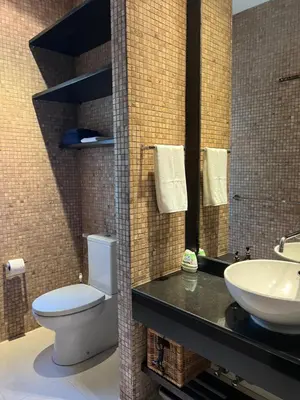 a bathroom with a toilet and a sink at Kata Gardens Apartments in Kata Beach