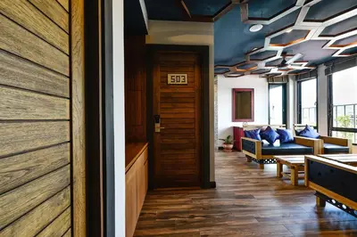 a hallway with a door and a couch in a room at Casa Bella Phuket in Chalong