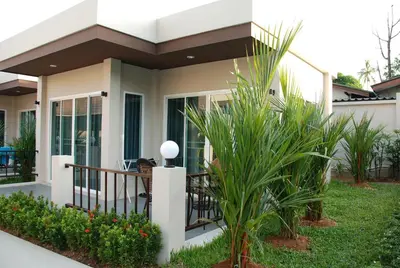 a house with a balcony with plants at Thuan Resort in Rawai Beach