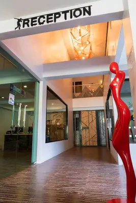 a red sculpture in front of a store at OneLoft Hotel in Karon Beach