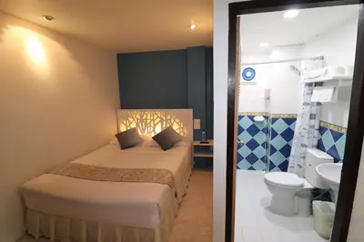 a hotel room with a bed and a bathroom at Summer Breeze Hotel in Patong Beach