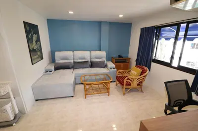 a living room with a couch and chairs at Summer Breeze Hotel in Patong Beach