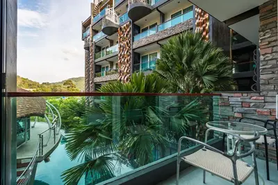 a view from the balcony of a hotel with a table and chairs at Emerald Terrace Apartments by Lofty in Patong Beach