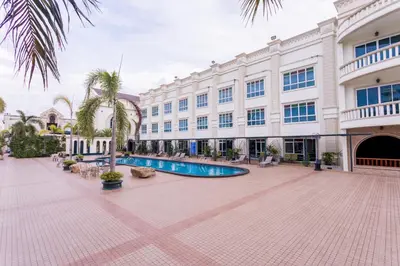 a building with a swimming pool in a courtyard at Erawan Phangnga Hotel, Natai Beach in Khok Kloi