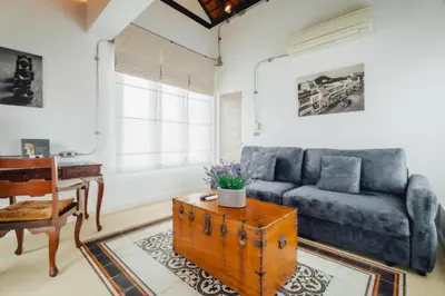 a living room with a couch and a table at Xinlor House - Phuket Old Town in Phuket Town