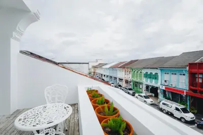 a balcony with a view of a city at Xinlor House - Phuket Old Town in Phuket Town