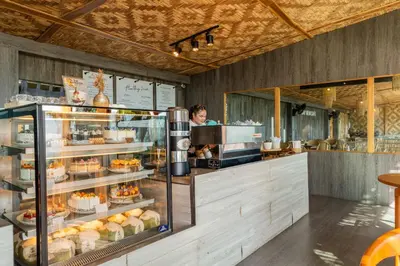 a woman standing behind a counter in a bakery at Sametnangshe Boutique in Phangnga