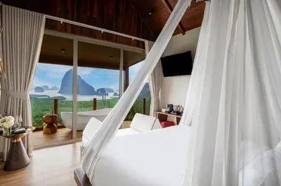 a bedroom with a bed and a large window at Sametnangshe Boutique in Phangnga