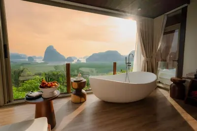 a bathroom with a large tub in front of a window at Sametnangshe Boutique in Phangnga