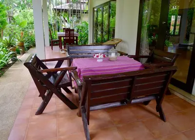 a wooden table with a purple table cloth on it at Symphony Villa in Nai Harn Beach