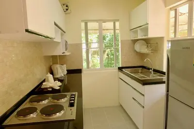 a small kitchen with a stove and a sink at Symphony Villa in Nai Harn Beach