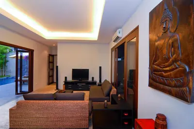 a living room with a couch and a wall art at Villa Susu by Holiplanet in Rawai Beach