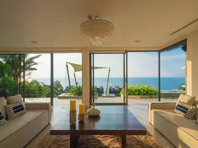 a living room with a couch and a table at Villa Samira by Elite Havens in Kamala Beach