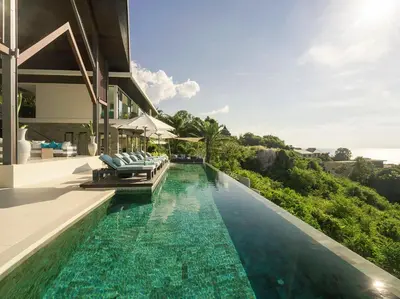 an infinity pool in a villa with blue water at Villa Samira by Elite Havens in Kamala Beach