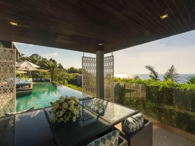 a patio with a glass table and a swimming pool at Villa Samira by Elite Havens in Kamala Beach