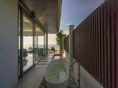 a bathroom with a bath tub on the side of a house at Villa Samira by Elite Havens in Kamala Beach