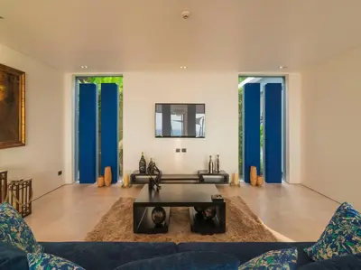 a living room with a couch and a table at Villa Samira by Elite Havens in Kamala Beach