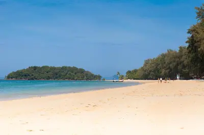 a beach with a group of people and the ocean at Baan Phukhao in Klong Muang Beach
