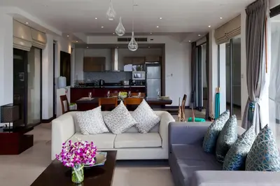 a living room with a couch and a table at Baan Phukhao in Klong Muang Beach