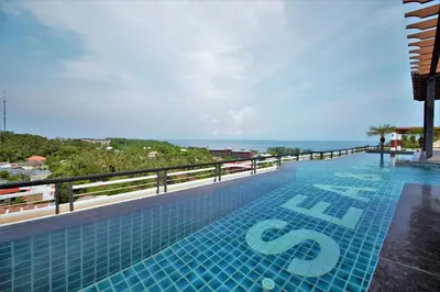 a swimming pool with a view of the ocean at Sea & Sky Karon Beach by PHR in Karon Beach