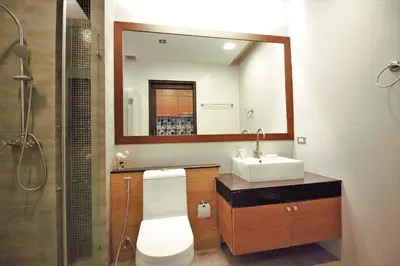 a bathroom with a toilet and a sink and a mirror at Sea & Sky Karon Beach by PHR in Karon Beach