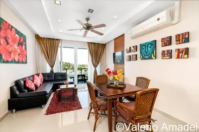 a living room with a table and a couch at Sea & Sky Karon Beach by PHR in Karon Beach
