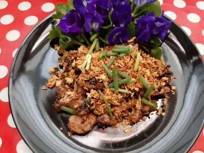 a plate of food on a table with purple flowers at Activities Resort in Ko Yao Yai