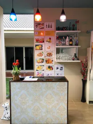 a restaurant with a counter with plates of food at Ban Don Holidayhome in Thalang