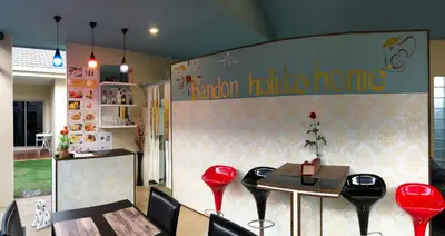 a restaurant with red chairs and a table and a counter at Ban Don Holidayhome in Thalang